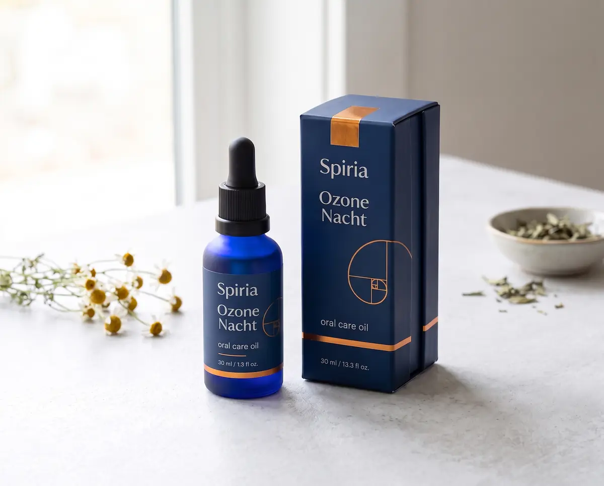 Spiria Ozone Nacht oral care oil with its carton on a pale stone surface